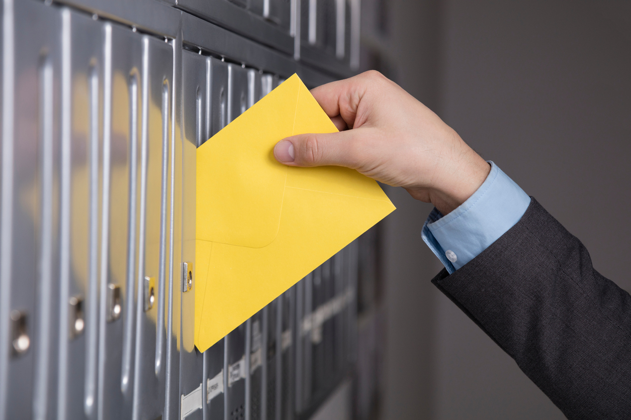 Mailman putting the letter into the mailbox