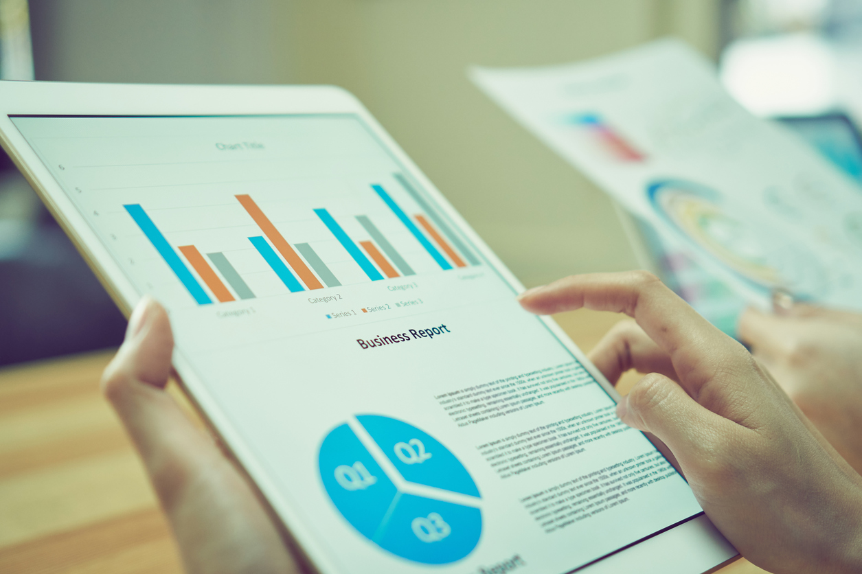 Business woman holding a tablet screen financial summary. To present to the team.